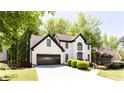Charming two-story home with a well-manicured lawn and lush green trees at 3612 Tree View Dr, Snellville, GA 30078
