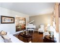 Elegant living room featuring a grand piano, hardwood floors, and sophisticated decor at 3612 Tree View Dr, Snellville, GA 30078