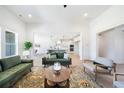 Bright living room with hardwood floors and large sofas, seamlessly connected to the modern kitchen at 185 Paislee Park (Lot #10 Paislee Park) Dr, Fayetteville, GA 30215