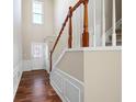 Entryway with hardwood floors and stairway with wood and white railings at 195 Finchley Dr, Roswell, GA 30076