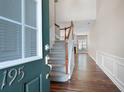 Entryway with hardwood floors, staircase, and view into the living room at 195 Finchley Dr, Roswell, GA 30076