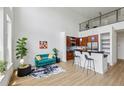 Open-concept living area with adjacent kitchen, featuring stylish furnishings and modern appliances, with a staircase to a lofted area at 747 Ralph Mcgill Ne Blvd # 337, Atlanta, GA 30312