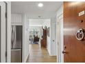Inviting condo hallway showcasing hardwood floors and a glimpse of the living area beyond at 1130 Piedmont Ne Ave # 907, Atlanta, GA 30309