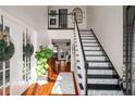 Bright foyer with high ceilings features a staircase with decorative treads and rich hardwood floors at 1354 Larson Sw Ct, Marietta, GA 30064