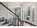 Inviting foyer with hardwood floors, staircase, and a view into the dining room at 2687 Ashford Ne Rd, Brookhaven, GA 30319