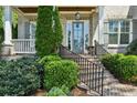 Close-up of an elegant front door with sidelights, brick stairs, and manicured landscaping at 2687 Ashford Ne Rd, Brookhaven, GA 30319