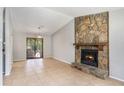 Spacious living room featuring a stone fireplace and sliding glass doors at 910 Brandon Hill Way, Jonesboro, GA 30238