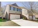 Charming two-story home featuring a two-car garage, brick accents, and a nice lawn at 2205 Capella Sw Cir, Atlanta, GA 30331