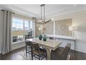 Bright dining room with a large window, stylish light fixture, and elegant decor, creating a welcoming atmosphere at 4256 Azalea Ridge Way, Hoschton, GA 30548