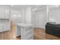 Bright living room with wood floors, a modern island and a comfortable seating area at 5300 Peachtree Rd # 1212, Atlanta, GA 30341
