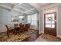 Elegant dining room with coffered ceilings, hardwood floors, and modern chandelier at 161 Dorys Way, Dallas, GA 30157