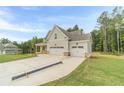 Beautiful two-story home featuring an attached two-car garage surrounded by lush trees at 210 Pinewood Dr, Covington, GA 30014