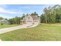 Beautiful two-story home featuring an attached two-car garage surrounded by lush trees at 210 Pinewood Dr, Covington, GA 30014