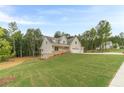 Beautiful two-story home featuring an attached two-car garage surrounded by a large front yard at 210 Pinewood Dr, Covington, GA 30014