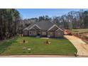 Sprawling lawn surrounds this brick home with long driveway at 25 Fourwood Dr, Covington, GA 30016