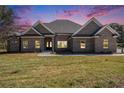 Charming brick home with manicured lawn and a covered front porch at 25 Fourwood Dr, Covington, GA 30016