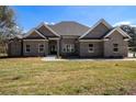 Charming brick home with manicured lawn and a covered front porch at 25 Fourwood Dr, Covington, GA 30016