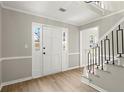 Foyer features a white door, hardwood floors, and a staircase with modern railings at 5427 Fieldgreen Dr, Stone Mountain, GA 30088
