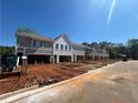 A newly built multi-Gathering unit shows two-car garages and attractive brick and board and batten construction at 125 Priestwood Ln, Acworth, GA 30102