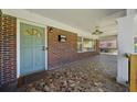 Covered front porch featuring mosaic tile flooring, a decorative light fixture, and a view of the yard at 1286 Calhoun Sw Ter, Atlanta, GA 30314