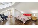 Cozy bedroom with natural light, a skylight, hardwood floors, and neutral decor at 156 Sisson Ne Ave, Atlanta, GA 30317