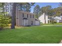 Traditional two-story home boasts a well-manicured lawn and attached single car garage at 2143 Victoria Pl, Lithonia, GA 30058