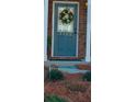 Close-up of the blue front door adorned with a seasonal wreath and house number at 3182 Mill Springs Cir, Buford, GA 30519