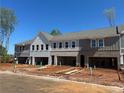 New townhomes showcase gray and white brick exteriors, and ready to plant front yards at 105 Priestwood Ln, Acworth, GA 30102