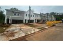 Street view of new townhomes featuring neutral siding, landscaping, and spacious driveways at 105 Priestwood Ln, Acworth, GA 30102