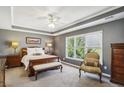 Serene bedroom with trey ceiling, neutral tones, and a large window for natural light at 173 Northshore Xing, Dallas, GA 30157