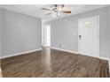 Bright living room with a ceiling fan, wood-look floors, and a white front door at 520 Crick Pt, Palmetto, GA 30268