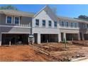 Exterior view of new construction homes showcasing gray siding and white brick accents, highlighting contemporary design at 101 Priestwood Ln, Acworth, GA 30102