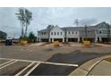 Street view of new townhome construction, featuring attached garages and modern architecture at 101 Priestwood Ln, Acworth, GA 30102