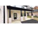 Charming entryway featuring a black front door, classic columns, and manicured landscaping at 355 Hilltop Cir Sw Ext, Mableton, GA 30126