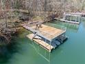 Modern boat dock with multi-level deck over water, perfect for relaxing and enjoying waterfront views at 3795 Duckcove Way, Cumming, GA 30041