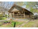 Quaint craftsman home featuring a cozy front porch, mature trees, and a well-maintained lawn at 857 Dill Sw Ave, Atlanta, GA 30310