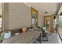 Inviting covered front porch with a rustic table and chairs, perfect for enjoying the outdoors at 857 Dill Sw Ave, Atlanta, GA 30310