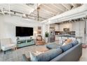 Open-concept living room with modern finishes, an open ceiling, and an adjacent kitchen at 1791 Harper Nw St # H, Atlanta, GA 30318