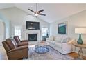 Cozy living room features a fireplace, ceiling fan, hardwood floors, and neutral decor for a relaxing atmosphere at 2593 Abbotts Glen Nw Dr, Acworth, GA 30101