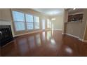 Spacious living room features gleaming hardwood floors, fireplace, and large windows at 4440 Cedar Bridge Walk, Suwanee, GA 30024