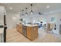 Bright, open-concept kitchen featuring a large island, stainless steel appliances, and modern pendant lighting at 113 Priestwood Ln, Acworth, GA 30102