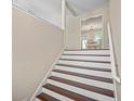 Elegant staircase featuring wood treads and white risers, leading to the upper level of the home at 404 Queensbury Pl, Acworth, GA 30102
