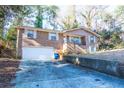 Brick home with a two-car garage and a concrete driveway at 2727 Whites Mill Ct, Decatur, GA 30034