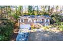Split-level brick home with a two-car garage and front yard at 2727 Whites Mill Ct, Decatur, GA 30034