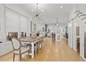 Open-concept dining area features a rustic wooden table, modern lighting, and seamless flow to the kitchen and living spaces at 273 Glenwood Se Ave # B, Atlanta, GA 30312