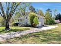Side view of a grey two-story home with a long driveway leading to a one car garage at 3582 Ontario Ct, Buford, GA 30519