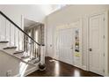 Bright foyer with hardwood floors, staircase, and transom windows above the door at 2842 Dover Nw Rd, Atlanta, GA 30327