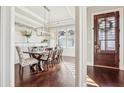 Elegant dining room featuring hardwood floors, modern lighting, and a decorative accent wall at 3363 Stetson Overlook Se, Smyrna, GA 30080