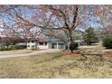 Beautiful home exterior with a spacious front yard, mature trees, and a two-car garage at 3376 Irish Ln, Decatur, GA 30032