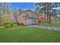 A detached garage with ample yard space surrounded by beautiful landscaping at 1045 Forest Path, Stone Mountain, GA 30088
